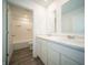 Bright bathroom with dual sinks, a shower-tub combo, and white cabinets at 1217 Fleming Dr, Greenfield, IN 46140