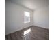 A simple bedroom with wood-look floors, ample sunlight, and fresh, neutral paint at 1217 Fleming Dr, Greenfield, IN 46140
