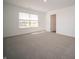 Bedroom featuring neutral carpet, a window for natural light and a paneled door at 1217 Fleming Dr, Greenfield, IN 46140