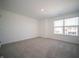 Bright bedroom featuring neutral carpet, white walls, and a large window offering plenty of natural light at 1217 Fleming Dr, Greenfield, IN 46140