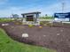 Stone community entrance sign framed by landscaping and a D.R. Horton 'Move-In Ready Homes' banner at 1217 Fleming Dr, Greenfield, IN 46140