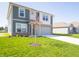 A two-story home with a lush green lawn, a spacious driveway, and a well-maintained exterior at 1217 Fleming Dr, Greenfield, IN 46140