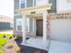 Inviting front entrance with a covered porch, brick accents, and well-manicured landscaping at 1217 Fleming Dr, Greenfield, IN 46140