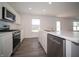 Modern kitchen features stainless steel appliances, white cabinets and marble countertops at 1217 Fleming Dr, Greenfield, IN 46140