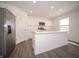 Modern kitchen boasts stainless steel appliances, a center island, marble countertops and white cabinets at 1217 Fleming Dr, Greenfield, IN 46140