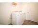 Functional laundry room with a white washer, dryer, and storage shelves at 1217 Fleming Dr, Greenfield, IN 46140