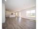 Open-concept living space with a dining area and a kitchen with white cabinets and stainless steel appliances at 1217 Fleming Dr, Greenfield, IN 46140