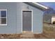 Gray front door adds to the curb appeal of this renovated home at 405 E 9Th St, Sheridan, IN 46069