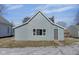 Newly renovated blue house with gray door and snow-covered lawn at 405 E 9Th St, Sheridan, IN 46069