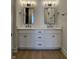 Bathroom featuring a double vanity with white cabinets, quartz countertops, and modern fixtures at 460 W Smoky Row, Carmel, IN 46032