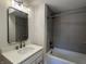 Modern bathroom with tiled shower and sleek vanity with mirror at 460 W Smoky Row, Carmel, IN 46032