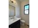 Modern powder room with a vanity sink, gold mirror, and a window at 460 W Smoky Row, Carmel, IN 46032
