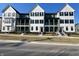 Modern townhomes showcase two-story designs with covered porches, and eye-catching black and white color schemes at 460 W Smoky Row, Carmel, IN 46032
