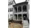 Inviting two-story home with a charming covered porch and well-manicured landscaping at 460 W Smoky Row, Carmel, IN 46032