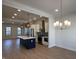 Spacious kitchen featuring a central island, stainless appliances, and modern pendant and chandelier lighting at 460 W Smoky Row, Carmel, IN 46032