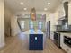 Open kitchen with a center island, stainless steel appliances, and views into the living area at 460 W Smoky Row, Carmel, IN 46032