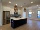 Bright kitchen showcasing a center island, stainless steel appliances, and pendant lighting fixtures at 460 W Smoky Row, Carmel, IN 46032