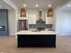 Modern kitchen featuring a large center island, stainless steel appliances, and stylish lighting at 460 W Smoky Row, Carmel, IN 46032