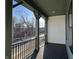 Covered porch overlooking the street and surrounding scenery at 460 W Smoky Row, Carmel, IN 46032