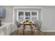 Modern dining area with a wooden table and six light-grey chairs at 1327 N Gale St, Indianapolis, IN 46201