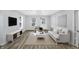Bright living room with hardwood floors, comfy sofa, and large TV at 1327 N Gale St, Indianapolis, IN 46201