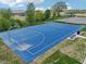 Aerial view of a blue basketball court surrounded by green space and trees at 236 Sam Himsel Way, Danville, IN 46122