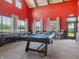 Entertainment room with a billiard table, red walls, and bar seating for recreation at 236 Sam Himsel Way, Danville, IN 46122