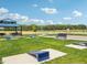 Outdoor community area with cornhole, picnic tables, a shelter, benches, and a lush green lawn for relaxation at 236 Sam Himsel Way, Danville, IN 46122