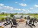Cozy community firepit with Adirondack chairs overlooking a pond and fountain feature at 236 Sam Himsel Way, Danville, IN 46122