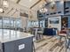 Open-concept living space with a modern kitchen, barstool seating, and adjacent seating area at 236 Sam Himsel Way, Danville, IN 46122
