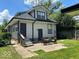 Back exterior featuring a patio with outdoor seating and a grassy yard at 4143 Graceland Ave, Indianapolis, IN 46208