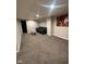 Carpeted basement living area with neutral walls, recessed lighting, and a seating area at 4143 Graceland Ave, Indianapolis, IN 46208