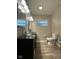 Bathroom with dual vessel sinks, a toilet, and wood look flooring at 4143 Graceland Ave, Indianapolis, IN 46208