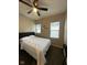 Bright bedroom with a ceiling fan, two windows, and modern decor at 4143 Graceland Ave, Indianapolis, IN 46208