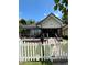Charming one-story home featuring a quaint front porch and lovely white picket fence at 4143 Graceland Ave, Indianapolis, IN 46208