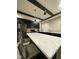 Bright kitchen with stainless steel appliances, a large marble island, and gold accents at 4143 Graceland Ave, Indianapolis, IN 46208
