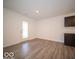 Spacious basement with vinyl plank flooring and an exterior access door at 6036 Card Blvd, Indianapolis, IN 46221