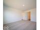 Large bedroom with neutral carpeting and two doors at 6036 Card Blvd, Indianapolis, IN 46221