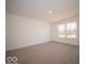 Bright bedroom with neutral carpeting and large window at 6036 Card Blvd, Indianapolis, IN 46221