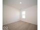 Simple bedroom with carpeted floor, neutral walls, and a window at 6036 Card Blvd, Indianapolis, IN 46221
