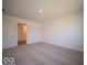 Spacious bedroom with neutral carpeting and access to bathroom at 6036 Card Blvd, Indianapolis, IN 46221