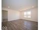 Large bonus room with wood-look flooring and window at 6036 Card Blvd, Indianapolis, IN 46221