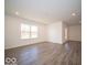 Spacious bonus room with wood-look flooring and window at 6036 Card Blvd, Indianapolis, IN 46221