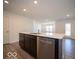 Open kitchen features a large island with quartz countertops and stainless steel dishwasher at 6036 Card Blvd, Indianapolis, IN 46221