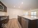 Modern kitchen with island, stainless steel appliances, and light wood flooring at 6036 Card Blvd, Indianapolis, IN 46221