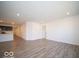 Open living area with wood-look floors and kitchen access at 6036 Card Blvd, Indianapolis, IN 46221