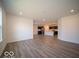 Open living room with wood-look flooring and kitchen view at 6036 Card Blvd, Indianapolis, IN 46221