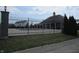 Community pool with black fence and green grass with a building in the background at 12912 Broncos Dr, Fishers, IN 46037