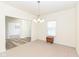 Bright dining room with neutral carpet, chandelier, and doorway to other room at 12912 Broncos Dr, Fishers, IN 46037