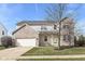 Charming two-story home featuring brick accents, a two-car garage, and a well-maintained lawn at 12912 Broncos Dr, Fishers, IN 46037